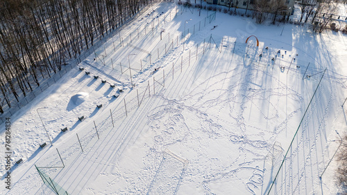 Drone photography of soccer, basketball and volleyball fields covered by snow during winter day photo