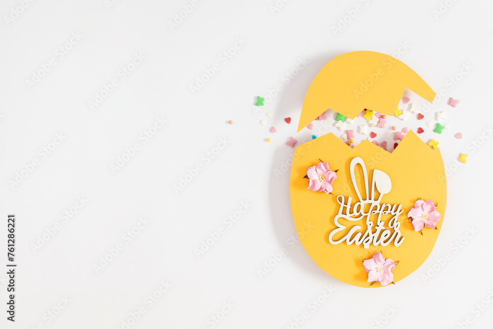 Easter decor concept. Frame made in shape of an Easter egg with colorful Easter eggs and sugar sprinkled candies on white background.Top view. Flat lay. Easter decor concept. Frame made in shape of an Easter egg with colorful Easter eggs and sugar sprinkled candies on white background.Top view. Flat lay.