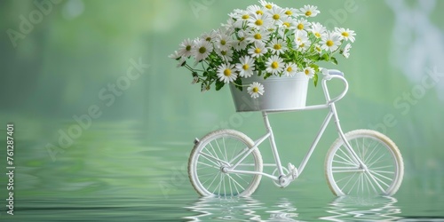 A white bicycle tricycle carrying flowers on a green background. photo