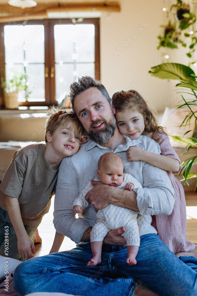 Portrait of father holding newborn baby, enjoying all his kids. New sibling. Unconditional paternal love, Father's Day concept. - obrazy, fototapety, plakaty 