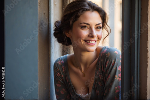 image of a beautiful female looking on a windowsill