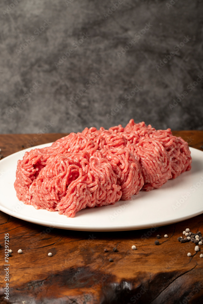 Ground beef. Butcher products. Fresh minced meat on dark background. Close up Ground beef. Butcher products. Fresh minced meat on dark background. Close up