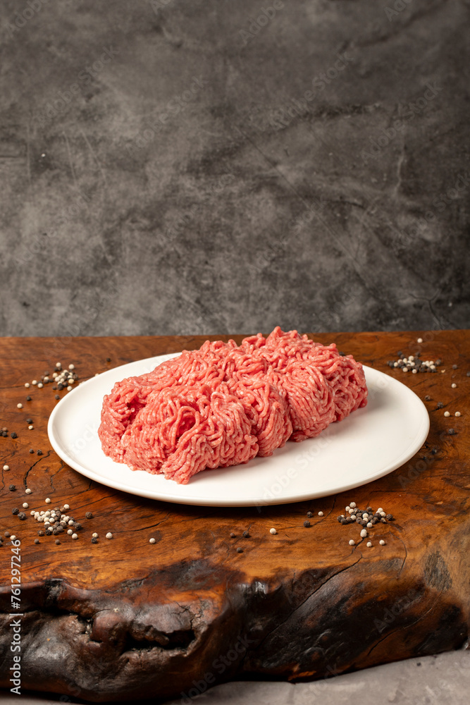 Ground beef. Butcher products. Fresh minced meat on dark background Ground beef. Butcher products. Fresh minced meat on dark background