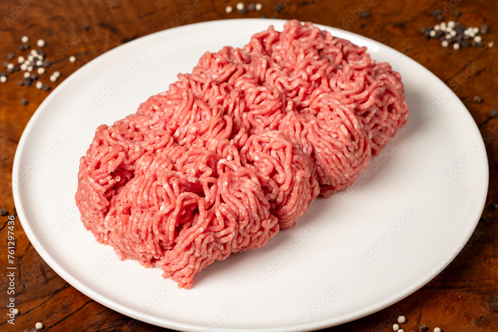 Ground beef. Butcher products. Fresh minced meat on dark background. Close up Ground beef. Butcher products. Fresh minced meat on dark background. Close up