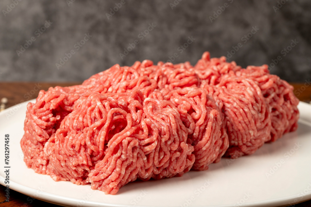 Ground beef. Butcher products. Fresh minced meat on dark background Ground beef. Butcher products. Fresh minced meat on dark background