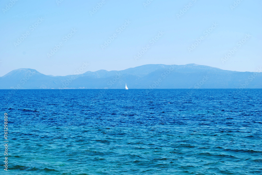 Yacht on the Adriatic sea on the mountains background. Sailing ship on the Croatia landscape. Travel concept and idea Yacht on the Adriatic sea on the mountains background. Sailing ship on the Croatia landscape. Travel concept and idea