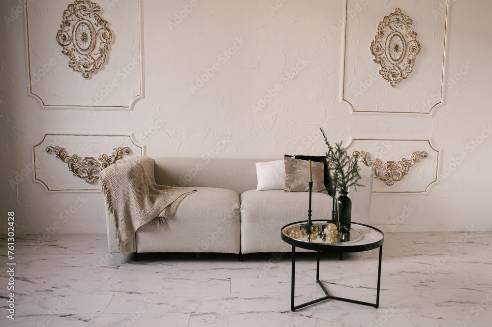 Stylish modern classic interior with sofa, table and stucco walls