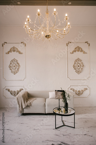 Stylish modern classic interior with sofa, table and stucco walls