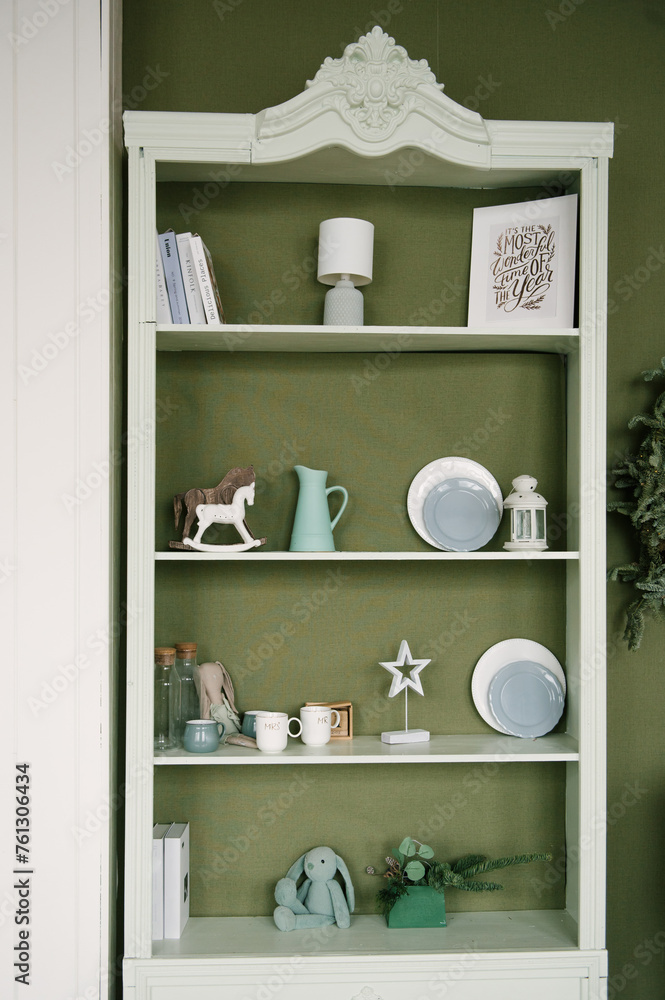 Stylish interior with a white sideboard and a Christmas tree decorated for the new year