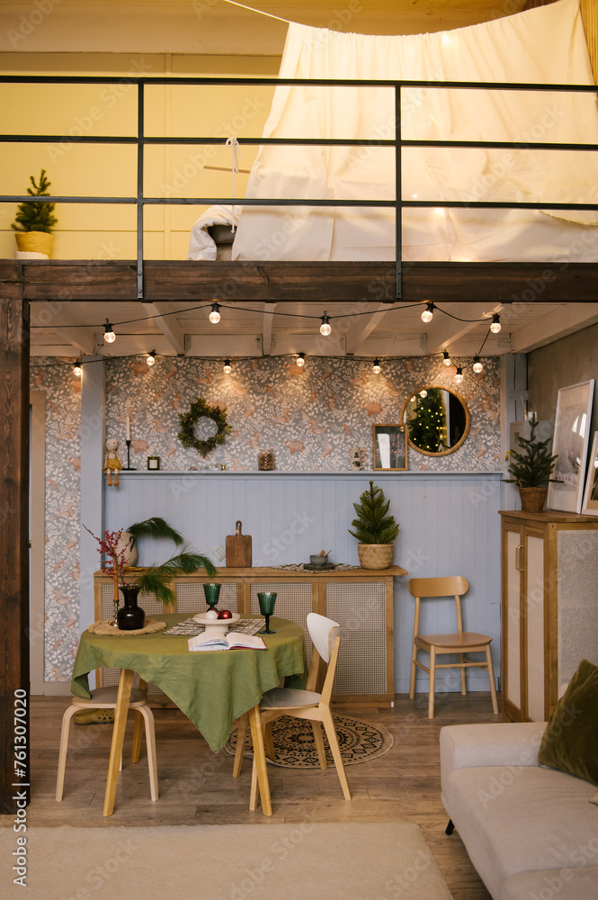 Interior design of a duplex apartment with a kitchen and a living room decorated for the new year