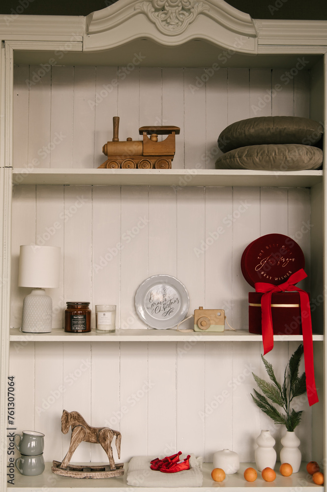 Stylish interior with a white sideboard and a Christmas tree decorated for the new year