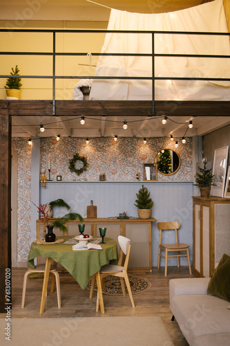 Obraz na płótnie Interior design of a duplex apartment with a kitchen and a living room decorated for the new year w salonie