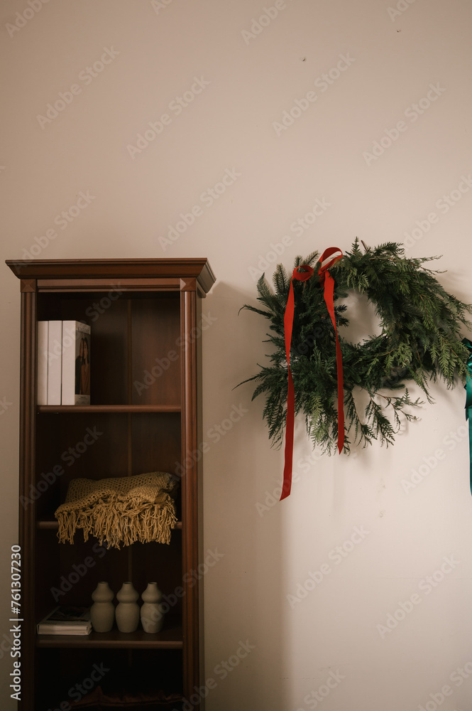 Stylish interior with a white sideboard and a Christmas tree decorated for the new year