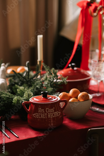 Obraz na płótnie Beautiful New Year decor, a Christmas table with a red tablecloth and candles, festive dishes and glasses w salonie