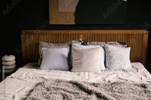 Obraz na płótnie Stylish modern japandi interior, wooden bed with beautiful textiles w salonie