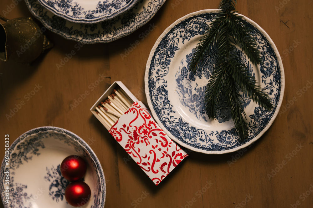 Beautiful New Year decor, red balls in vintage plates and gold candlesticks