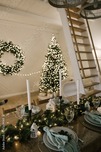 Obraz na płótnie Beautiful New Year's decor at home, the table is set for the holiday against the background of the lights of the Christmas tree w salonie