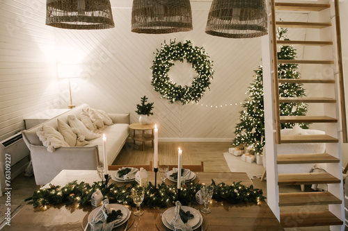 Obraz na płótnie Beautiful New Year's decor at home, the table is set for the holiday against the background of the lights of the Christmas tree w salonie