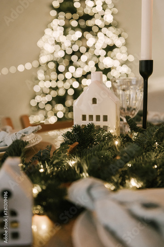 Obraz na płótnie Beautiful New Year's decor at home, the table is set for the holiday against the background of the lights of the Christmas tree w salonie