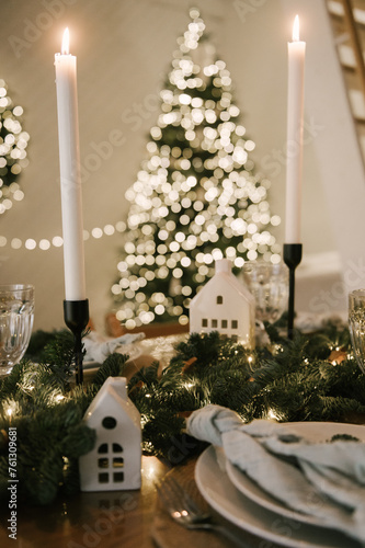 Obraz na płótnie Beautiful New Year's decor at home, the table is set for the holiday against the background of the lights of the Christmas tree w salonie