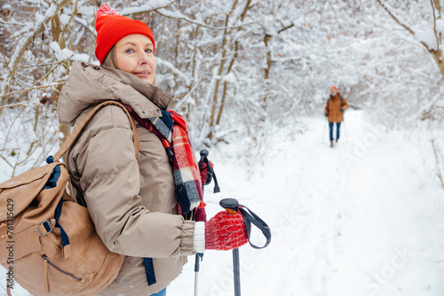 Mature couple feeling enjoyed while having a walk in a winter park