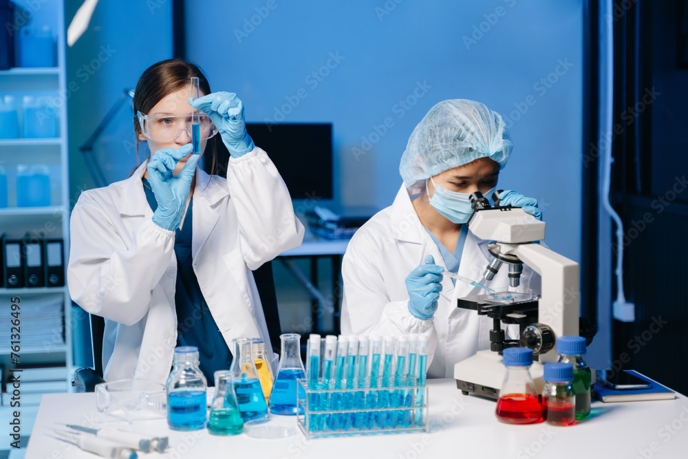 Two Female biotechnologist testing new chemical substances in a laboratory. Two Female biotechnologist testing new chemical substances in a laboratory.