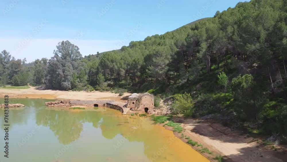 Aerial drone view of old watermill in the shore of Odiel river in the hiking route of the water mills along the Odiel river from Sotiel Coronada, in Huelva province, Andalusia, Spain Aerial drone view of old watermill in the shore of Odiel river in the hiking route of the water mills along the Odiel river from Sotiel Coronada, in Huelva province, Andalusia, Spain