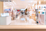 Abstract blurred image of cosmetics department store in the mall with empty table top