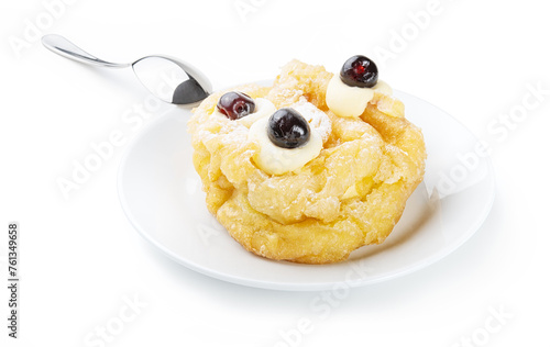 Bignè di San Giuseppe fritto, fried zeppola, Italian dessert with plate and teaspoon isolated on white background, close-up.