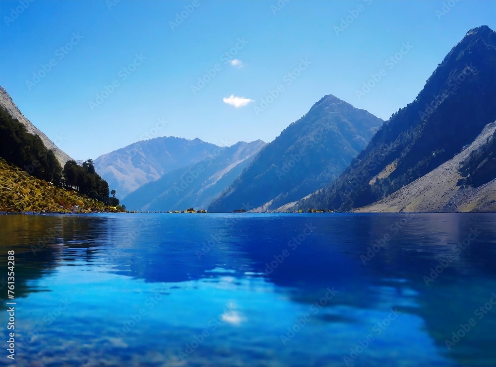 Deep blue lake and sky, surrounded by the silhouette of the mountains. Travel background.