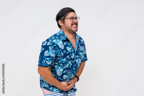 Urgent need to pee concept with a middle-aged man pressing his hands against his lower abdomen, isolated against a white background.