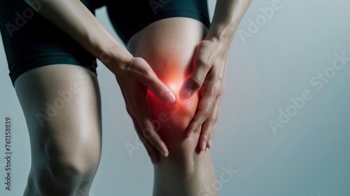 Woman with knee pain. Joint problems and arthritis highlighted with a red tone. Health and medical concept.