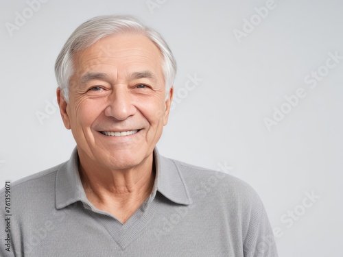Portrait of a senior man with grey hair and a bright smile