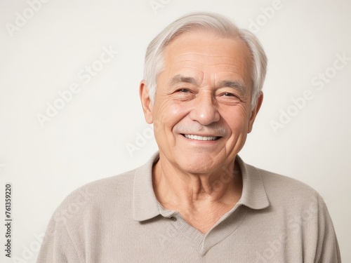 Portrait of a senior man with grey hair and a bright smile