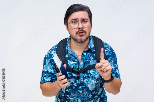 Anxious middle-aged male traveler with backpack holds passport and boarding pass, gesturing for attention. Asking for one more chance. photo