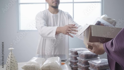 Muslim Man Giving Food Donation and Other Receive It. Zakat for Islamic Charity on Ramadan Month. 