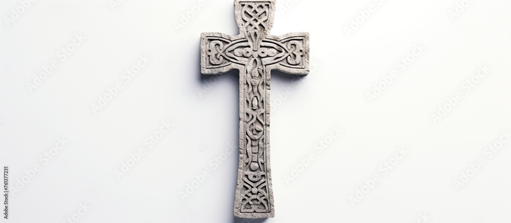 A Religious item, the silver Cross, is displayed on a white surface. This Crucifix is a Symbol of faith and a fashionable accessory