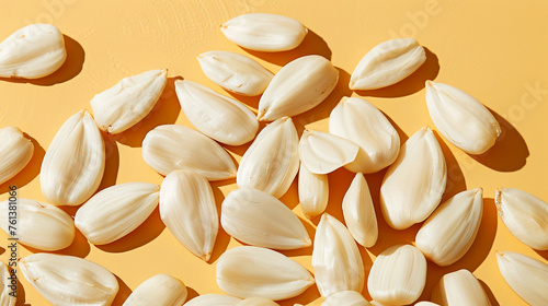 commercial stock flat lay photo of small pile of about five raw white sunflower seeds against light tan background сreated with Generative Ai © Andrii Yablonskyi