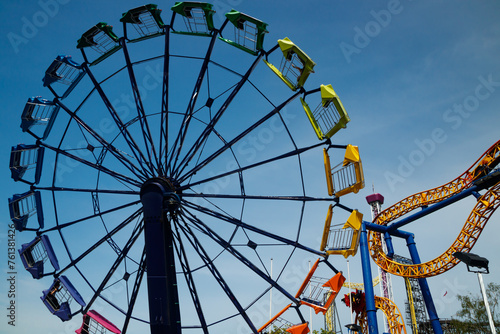 Colorful rides in motion in amusement park on sky background. photo