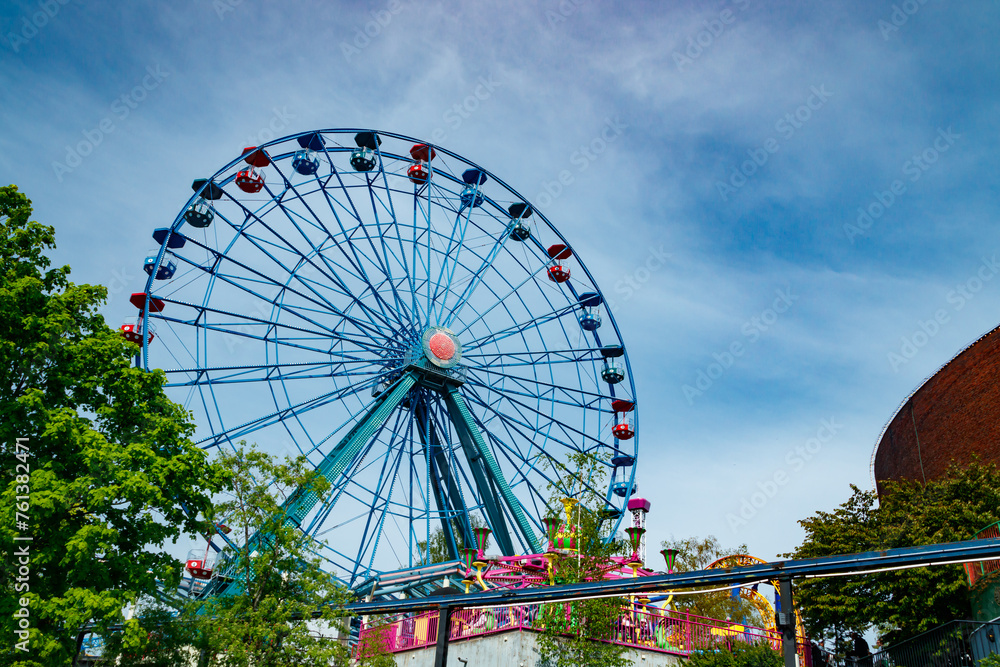Colorful ride ferris wheel in motion in amusement park on sky background. Colorful ride ferris wheel in motion in amusement park on sky background.