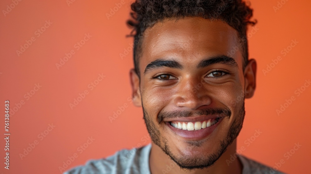 portrait of smiling hispanic man on an orange background, copy space, horizontal portrait of smiling hispanic man on an orange background, copy space, horizontal