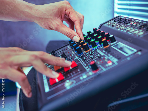 Sound engineer hands adjusting control sound mixer in recording, broadcasting studio,Sound mixer. Professional audio mixing console, buttons, faders and sliders. sound check.