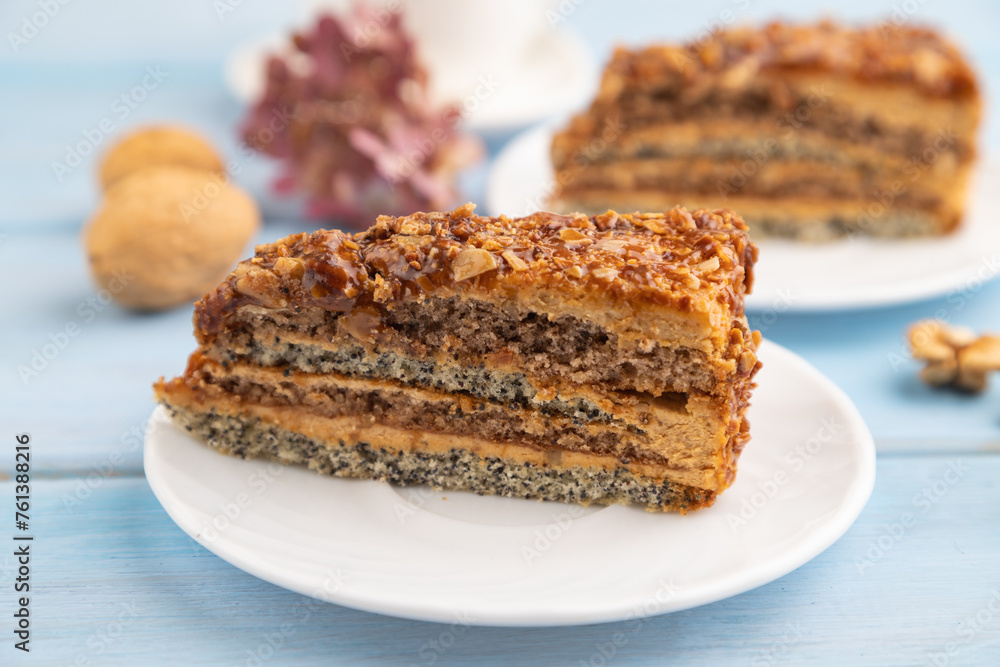 Walnut and hazelnut cake with caramel on blue wooden. side view, copy space, selective focus. Walnut and hazelnut cake with caramel on blue wooden. side view, copy space, selective focus.