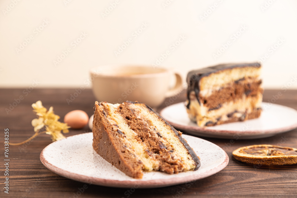 Chocolate biscuit cake with caramel cream on brown wooden. side view, selective focus Chocolate biscuit cake with caramel cream on brown wooden. side view, selective focus