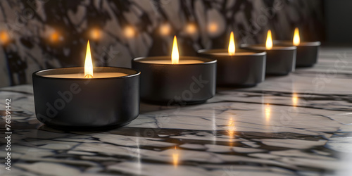 Low light image row of candle flames glowing against marble walls and counter on dark background