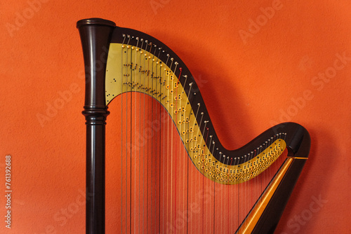 Canvastavla Harp isolated on orange background. Wooden musical instrument.