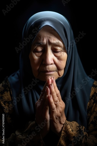 A woman in a headscarf praying with clasped hands.. Fictional character created by Generated AI. 