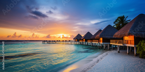 Tropical beach panorama view, Bungalows stay in Sea, coastline with palms, Caribbean sea under sunset light.