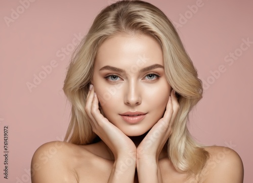 l blonde woman with healthy skin looks at the camera and touches her face with her hands