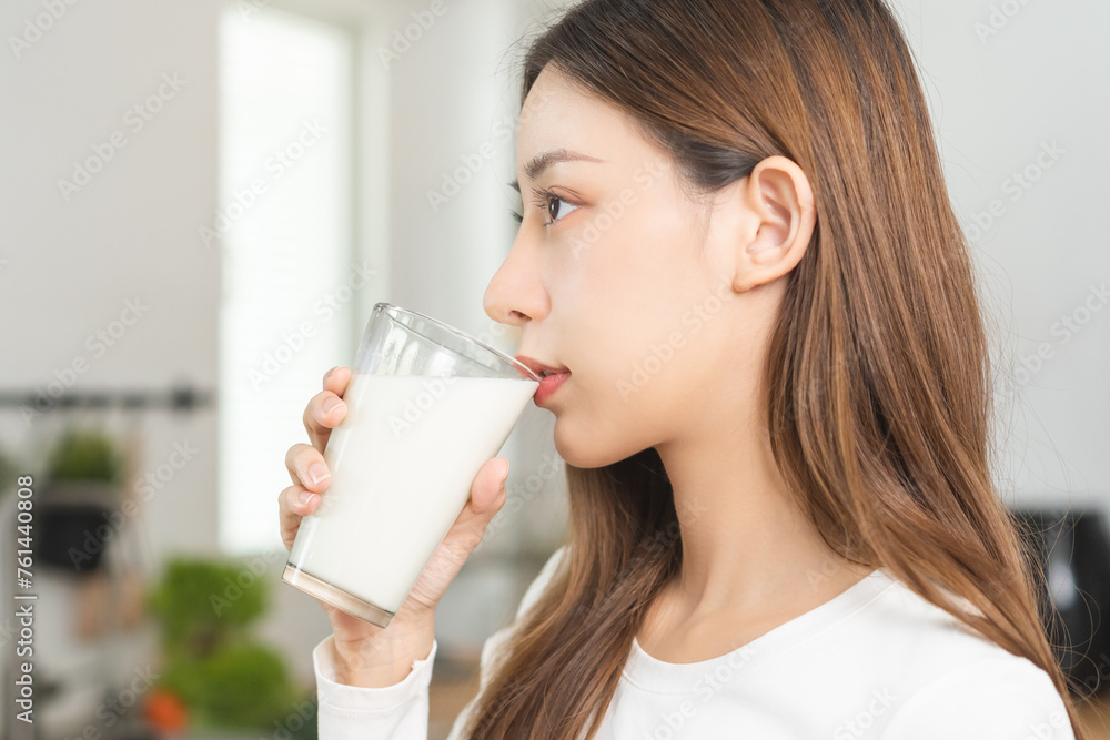 Health care, pretty asian young woman, girl drinking a glass of white fresh, dairy milk for calcium, vitamin wholesome good nutrition in morning at kitchen home. lifestyle, product healthy people. Health care, pretty asian young woman, girl drinking a glass of white fresh, dairy milk for calcium, vitamin wholesome good nutrition in morning at kitchen home. lifestyle, product healthy people.
